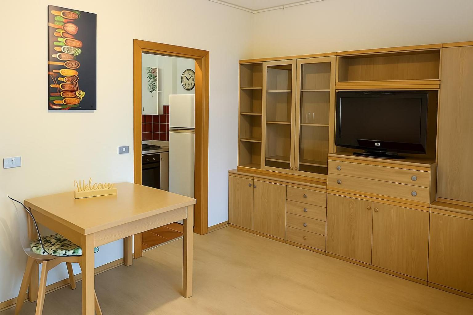 The dining area with the table and the wooden sideboard