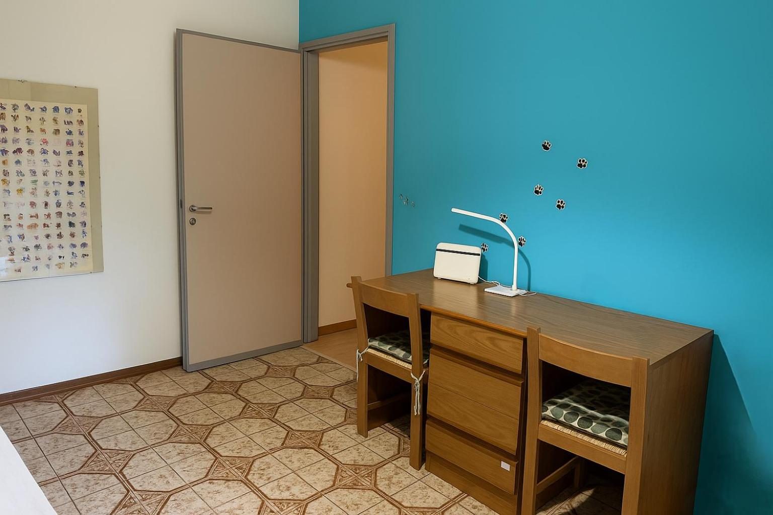 A wooden desk against the blue wall