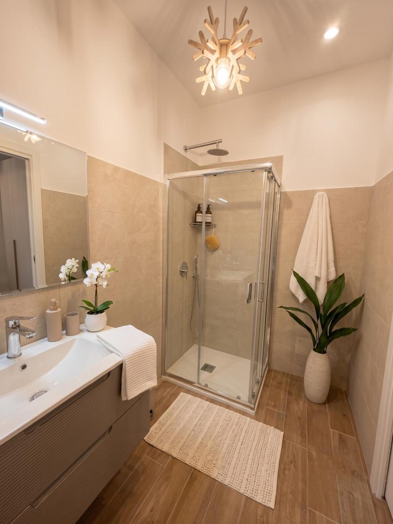 The bathroom: glass shower and vanity unit