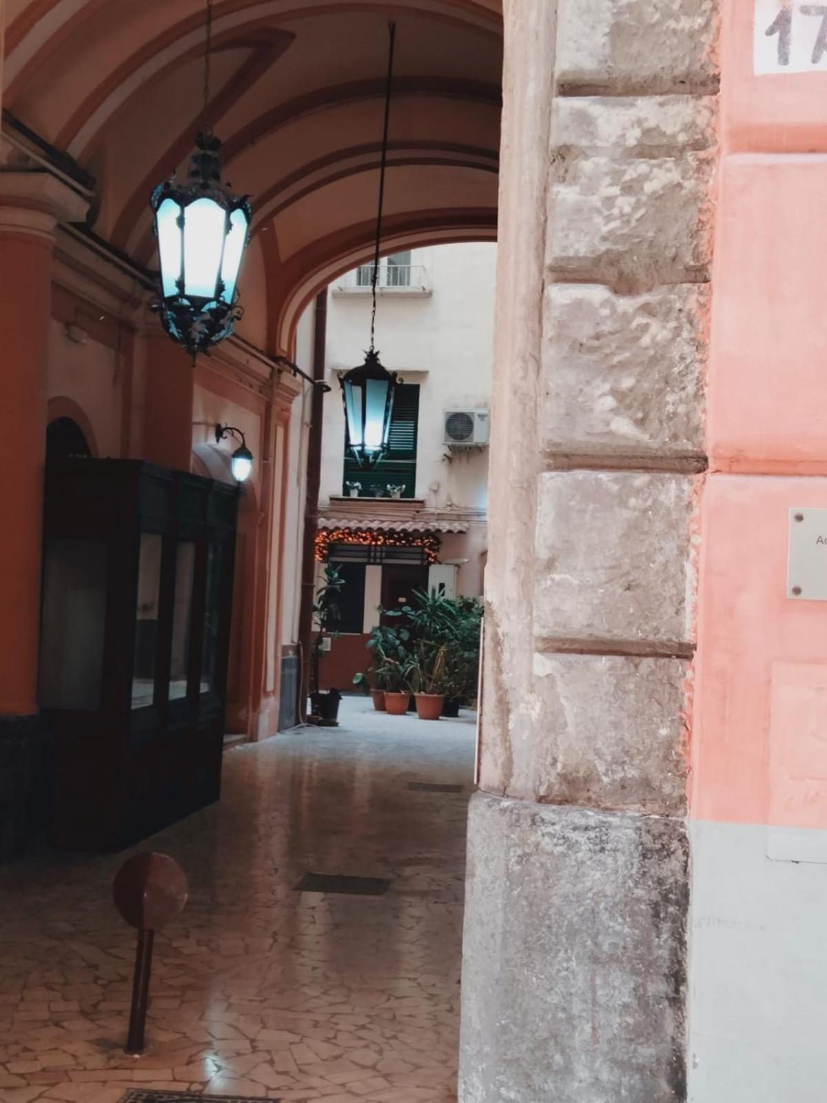 The building's entrance hall, with lanterns and the light from the lane