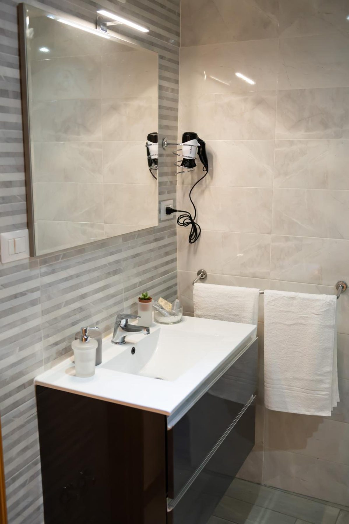 The bathroom: basin, mirror and hairdryer