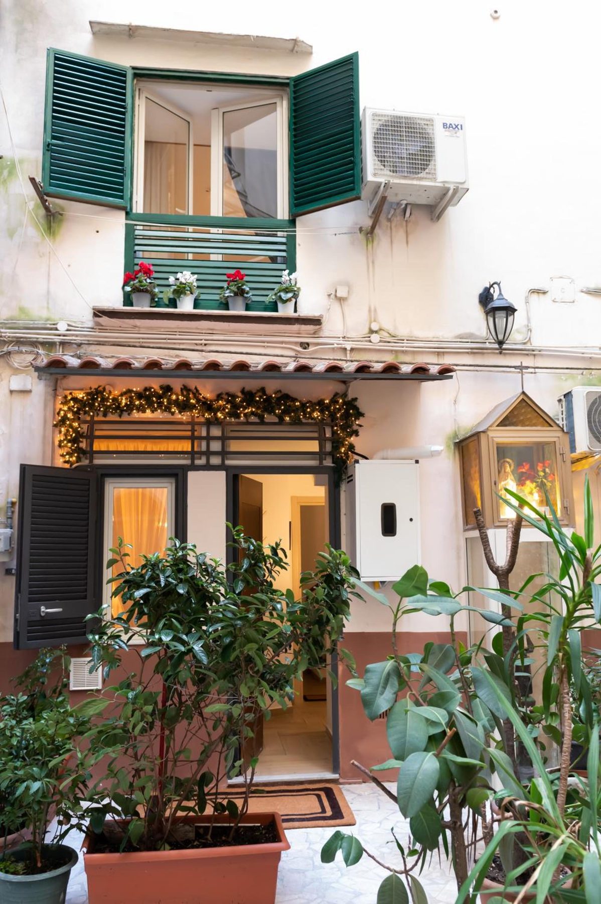 The inner courtyard, with plants and the green balcony