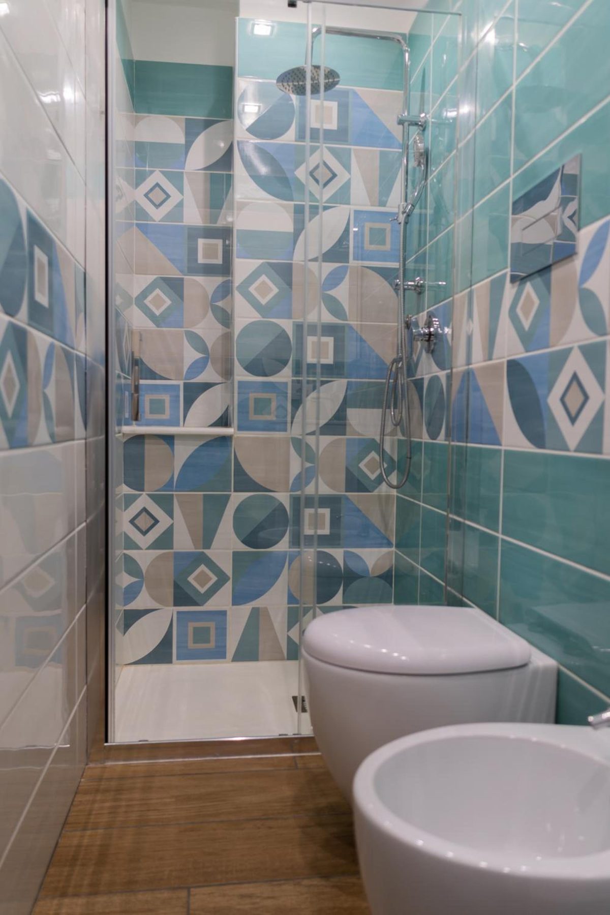 Bathroom with blue geometric tiles and the shower