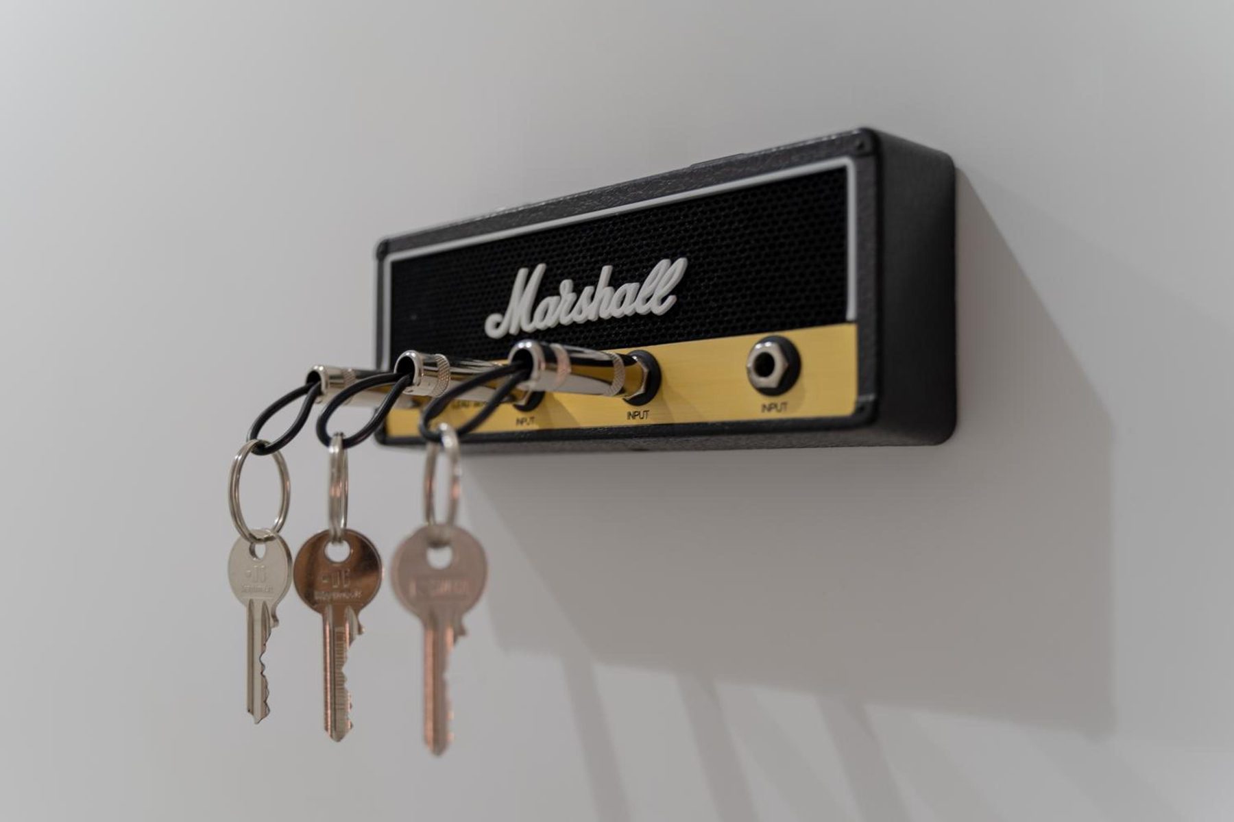The keys hanging on an amplifier-shaped key holder